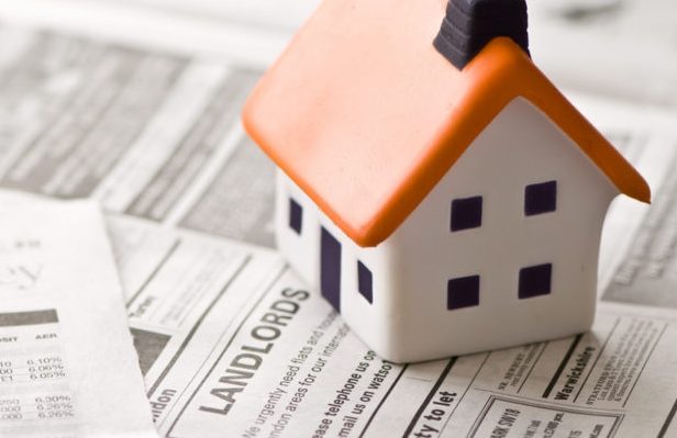 Landlords sell properties illustration image Model house on a newspaper with property listings.